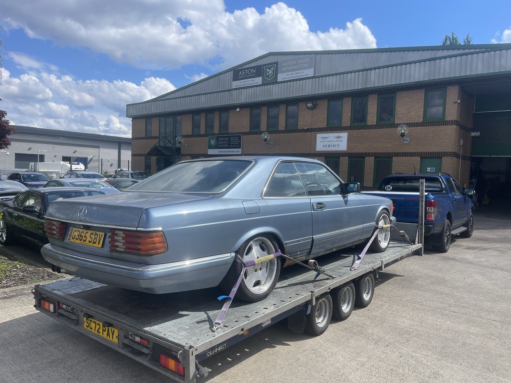 Silver Mercedes coupe on the trailer at a specialist workshop